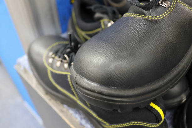 A pile of old black leather shoes